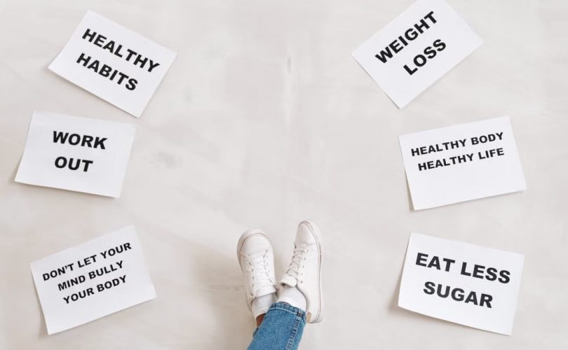 Inspirational health and fitness messages with shoe-clad feet, promoting healthy habits and wellbeing.